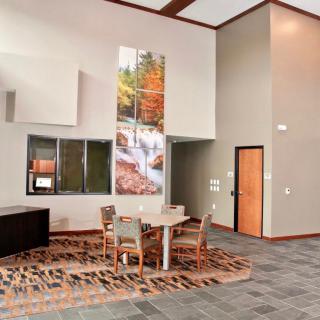 A modern lobby with a seating area, decorated with artwork and contemporary furniture.