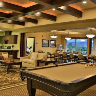 A stylish and cozy recreation area featuring a pool table and comfortable seating.