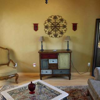 A vintage-style living room with a decorative cabinet and armchair.