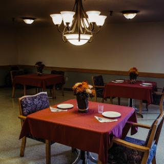 A well-arranged dining area with red tablecloths and elegant lighting.