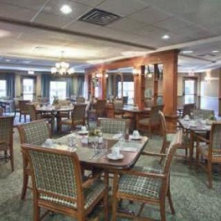 A cozy dining area with neatly set tables and comfortable seating.