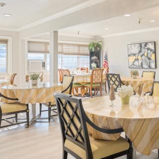 A bright and elegantly decorated dining room with multiple tables and chairs.