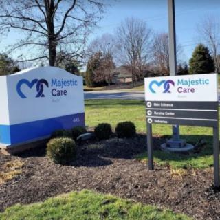 Outdoor signs for Majestic Care with landscaped surroundings.