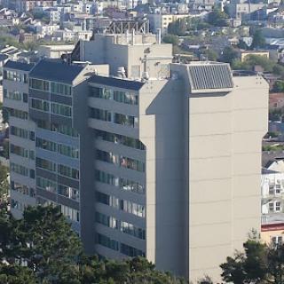 A modern multi-story building in an urban setting, showcasing contemporary architectural design.