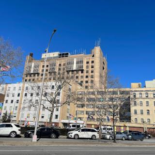 A sunny day view of a multi-story building against a clear blue sky.