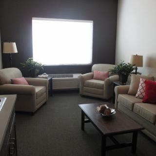 A cozy living room with comfortable seating and a large window.