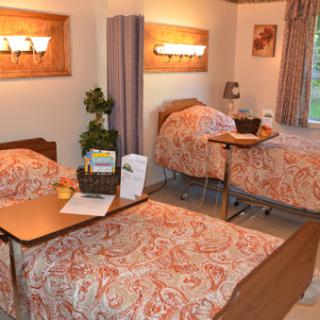 A cozy hospital room featuring two patient beds, designed for comfort and care.