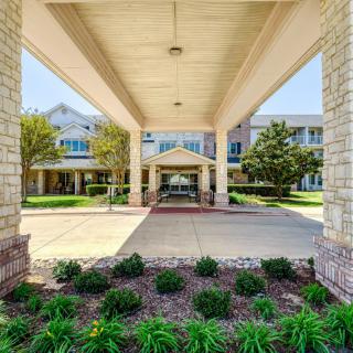 A welcoming building entrance with a landscaped pathway.