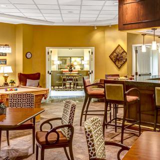 A cozy lounge area with a bar, featuring comfortable seating and stylish decor.