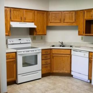 A kitchen featuring wooden cabinets, a stove, an oven, and a dishwasher.