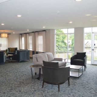 A modern living room with comfortable seating and large windows.