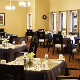 An elegant dining room with tables set for guests.