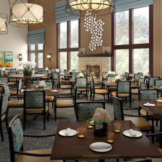 A spacious and elegantly decorated dining room with large windows and ambient lighting.