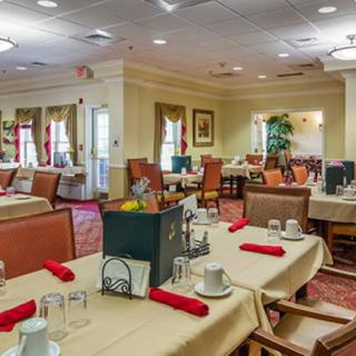 A well-decorated dining room with neatly arranged tables and chairs.