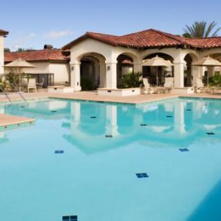 A luxurious resort with a large swimming pool and elegant architecture.