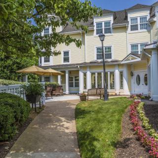 A scenic view of a residential building with landscaped gardens and a pathway.