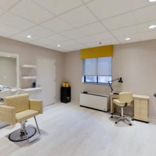 A modern hair salon with stylish furnishings and bright lighting.