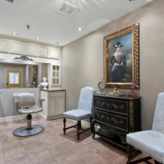Elegant salon interior with classic furniture and artwork.