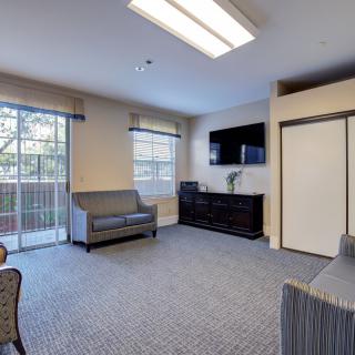 A comfortable living room with modern furniture and a large window allowing natural light.