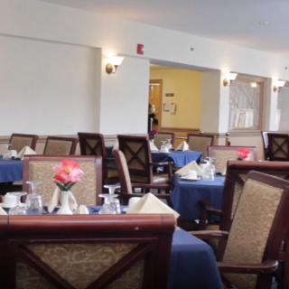A neatly arranged dining area with tables set for service.