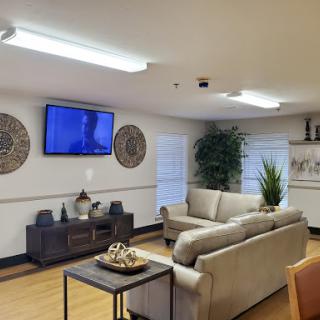 A cozy living room featuring a comfortable sofa, a television, and stylish decor.