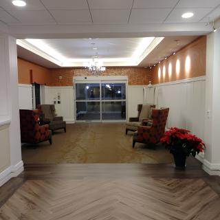 A cozy lobby area with comfortable chairs and warm lighting.