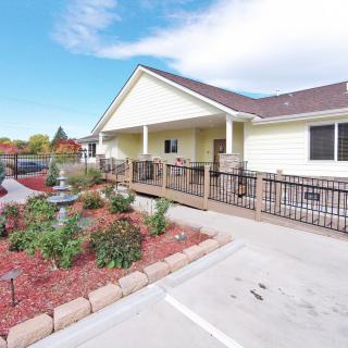 A single-story house with a landscaped garden and accessible ramp.