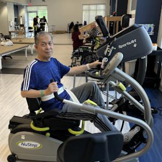 A person engaging in exercise on a specialized workout machine at the gym.