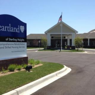 Entrance to a healthcare facility with a visible sign and flag.