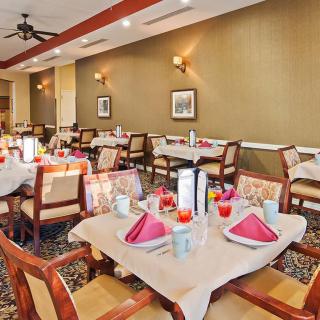 A neatly arranged dining area with tables set for guests in a restaurant.