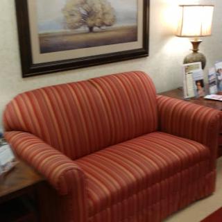 A cozy striped couch in a warmly decorated living room.