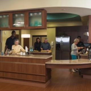 A group of people enjoying time together in a modern kitchen setting.