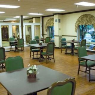A spacious dining room with multiple tables and chairs arranged neatly.