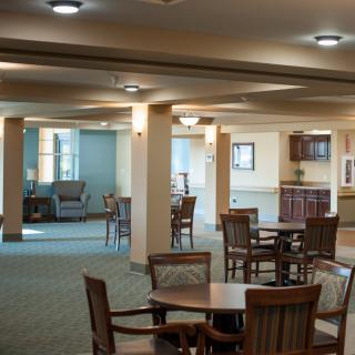A spacious and well-lit interior with tables and chairs arranged in an open layout.