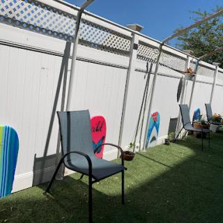 A sunny outdoor space featuring decorated walls and empty chairs, perfect for relaxation.