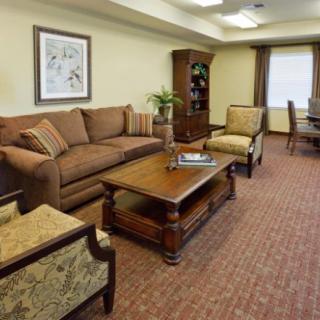 A cozy living room with a comfortable sofa and armchairs, complemented by a coffee table and elegant decor.