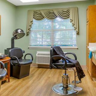 A cozy hair salon interior with styling chairs, a sink, and a hair dryer.