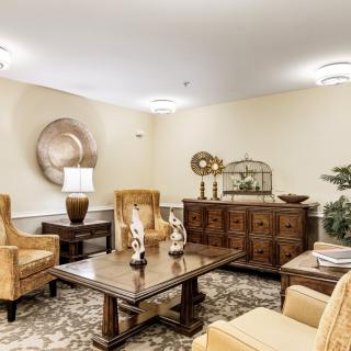 A traditional living room with elegant furniture and decorative accents.