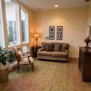 Cozy living room with a sofa, armchair, and decorative items.