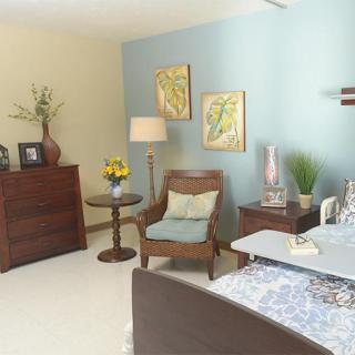 A cozy living room with wooden furniture and decorative elements.