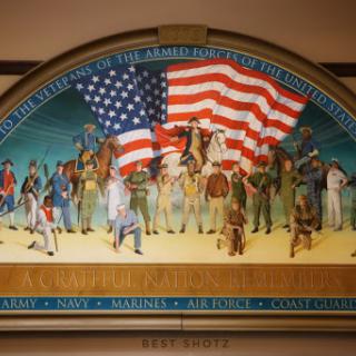 A vibrant mural depicting a diverse group of historical figures united under the American flag.
