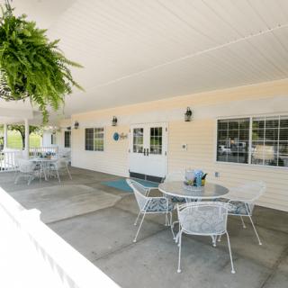 A welcoming covered patio with tables and chairs for outdoor relaxation.