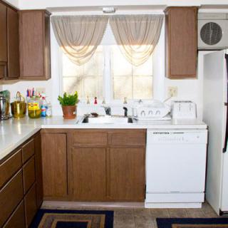 A cozy kitchen with wooden cabinets, a sink, and various appliances.