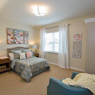 A cozy modern bedroom with elegant decor and comfortable furniture.