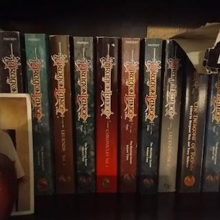 A collection of fiction novels displayed on a shelf.