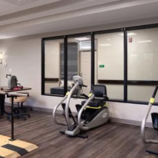A modern gym area featuring stationary bikes and fitness equipment.