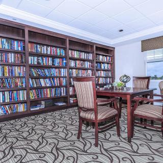 A cozy library reading area with bookshelves and comfortable seating.