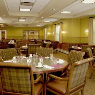 A spacious dining room with neatly arranged tables and chairs.