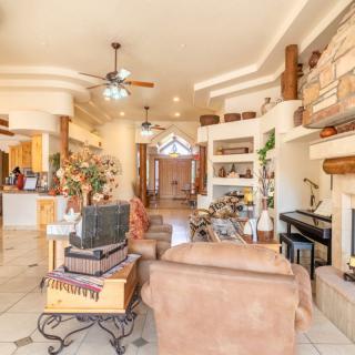 A spacious and elegantly designed living room with comfortable furniture, decorative shelves, and a cozy fireplace.