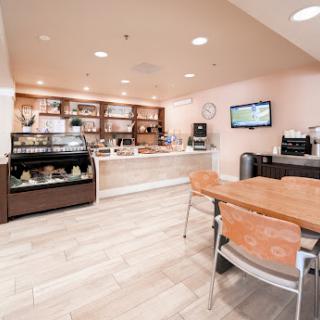 A modern caf interior featuring a coffee counter and seating area.